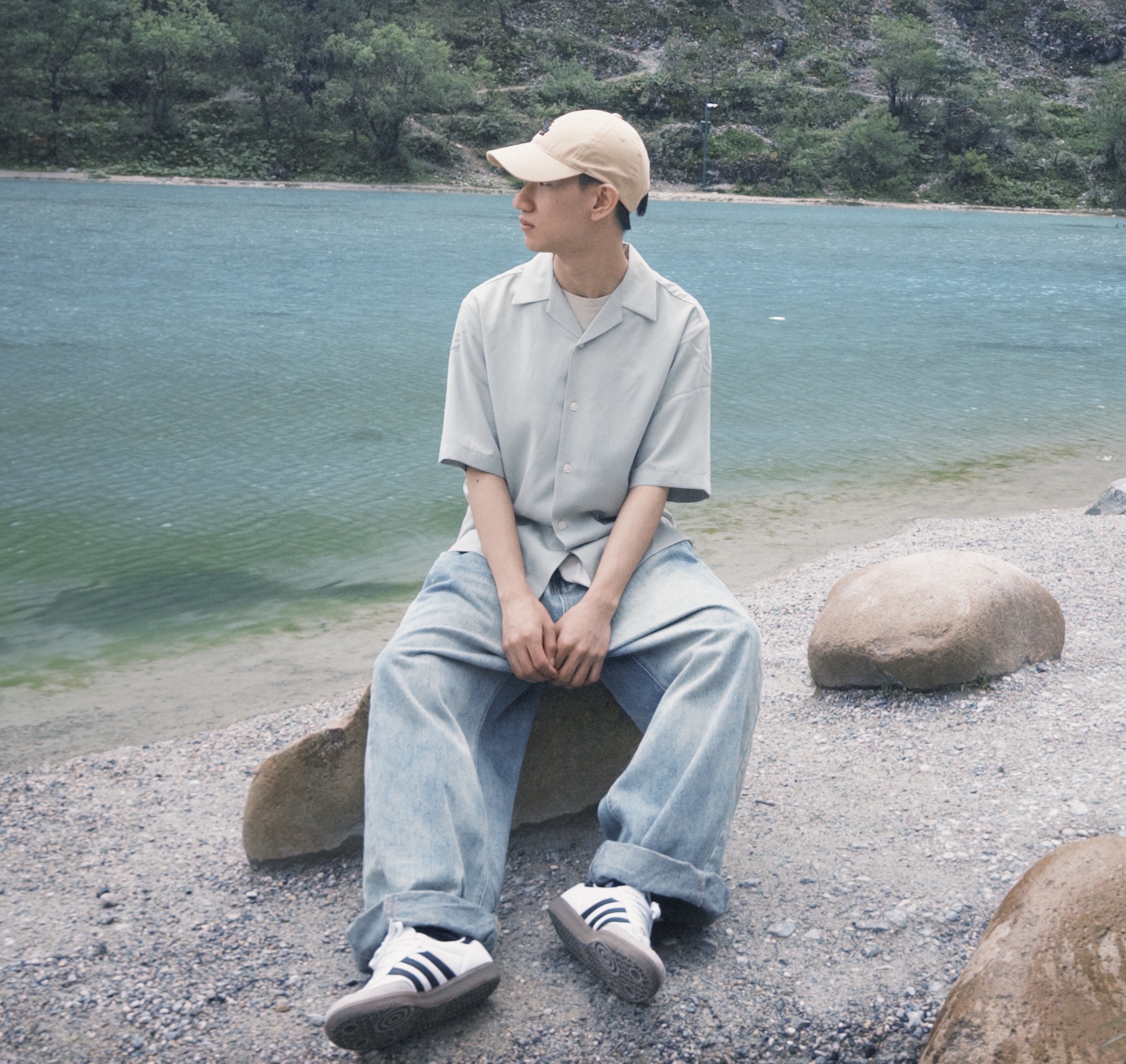 Johnny Lui sitting beside a lake in Hong Kong
